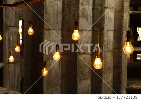 Old model Glow bulbs hanging in the dark at night 137721139