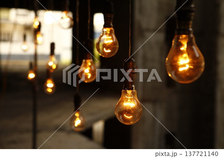 Old model Glow bulbs hanging in the dark at night Old model Glow bulbs hanging in the dark at night 137721140