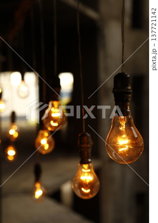 Old model Glow bulbs hanging in the dark at night Old model Glow bulbs hanging in the dark at night 137721142