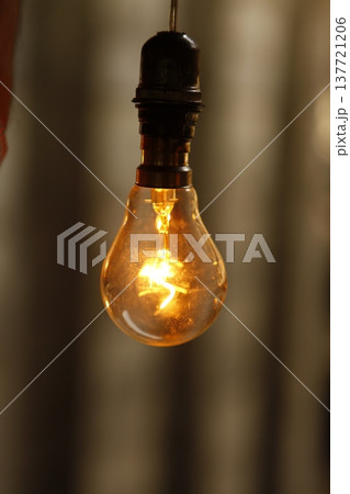 Old model Glow bulb hanging in the dark at night Old model Glow bulb hanging in the dark at night 137721206