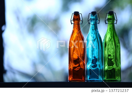 Empty Color Glass Bottle on the table Empty Color Glass Bottle on the table 137721237