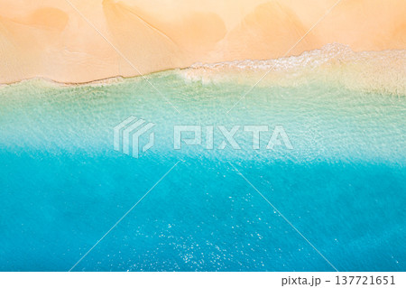 Stunning summer seascape aerial view with bright blue ocean waves sparkling under sunny sky, tropical beach shoreline, soft golden sunset light, top view from drone, serene nature paradise Stunning summer seascape aerial view with bright blue ocean waves sparkling under sunny sky, tropical beach shoreline, soft golden sunset light, top view from drone, serene nature paradise 137721651