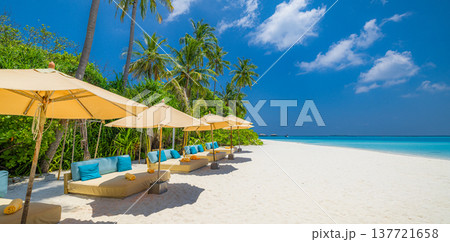Radiant summer beach resort with umbrellas and sunbeds under sunny sky, golden sand, relaxing tropical holiday vibes, serene summer escape 137721658