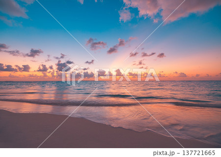Radiant sunset over tropical beach with calm ocean and peaceful waves, immersive colorful sky and clouds, serene summer nature landscape, idyllic vacation mood Radiant sunset over tropical beach with calm ocean and peaceful waves, immersive colorful sky and clouds, serene summer nature landscape, idyllic vacation mood 137721665