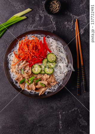 Bowl of rice noodles with vegan soy meat and vegetables. 137722491