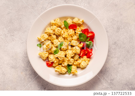 pasta in a plate with tomato sauce. 137722533