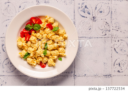 pasta in a plate with tomato sauce. pasta in a plate with tomato sauce. 137722534