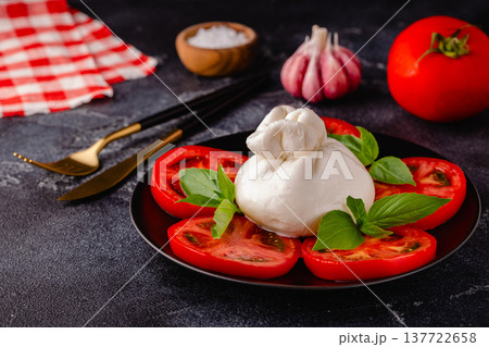 Caprese salad with tomatoes, burrata cheese and basil. 137722658
