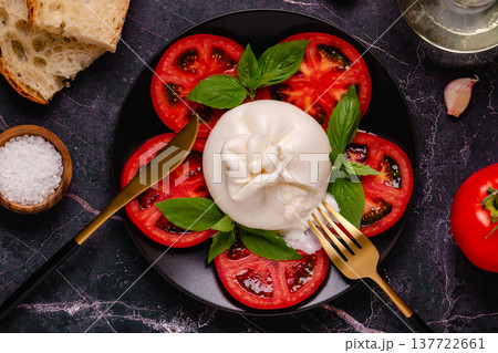 Caprese salad with tomatoes, burrata cheese and basil. 137722661