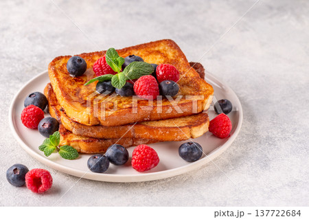 French toast with blueberries, raspberries, maple syrup 137722684
