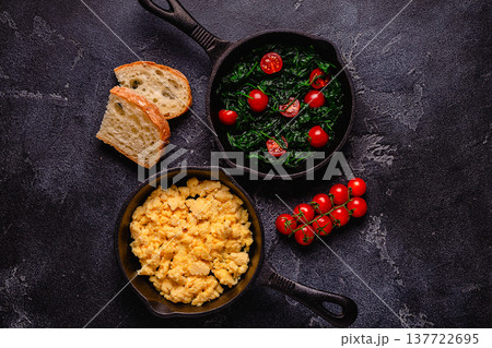 Cooked omelet and spinach with tomatoes in pans Cooked omelet and spinach with tomatoes in pans 137722695