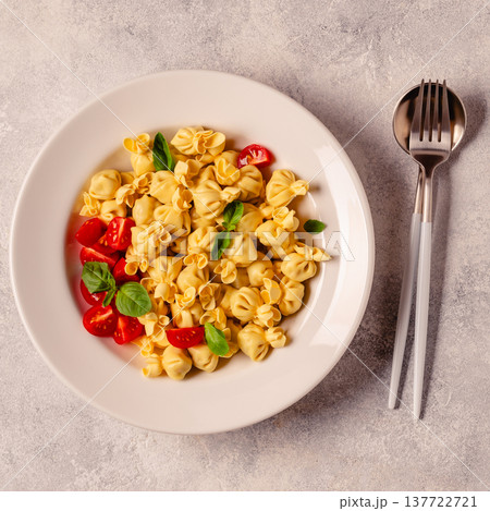 pasta in a plate with tomato sauce. 137722721