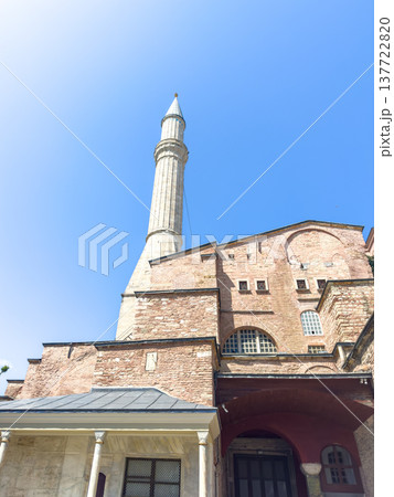 The architecture of the historic Hagia Sophia Mosque with a tall minaret against a clear blue sky. The architecture of the historic Hagia Sophia Mosque with a tall minaret against a clear blue sky. 137722820
