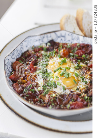 Shakshuka brunch dish on white table at outdoors restaurant in israel Shakshuka brunch dish on white table at outdoors restaurant in israel 137724838