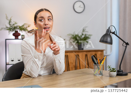 Young businesswoman records voice message states argument and listens to reply on smartphone speaker 137725442