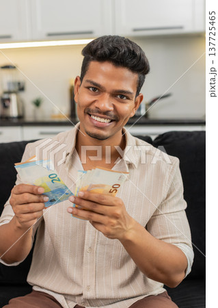 Indian man counts euro cash happy makes money gesture plans dream purchase savings bonus invest plan Indian man counts euro cash happy makes money gesture plans dream purchase savings bonus invest plan 137725465
