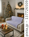 A knitted throw with a floral pattern on a sofa in a bright living room. AI 137726509