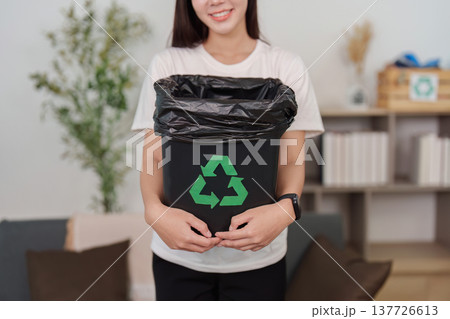 Waste Management. Young woman holding recycling bin with plastic waste. Waste Management. Young woman holding recycling bin with plastic waste. 137726613