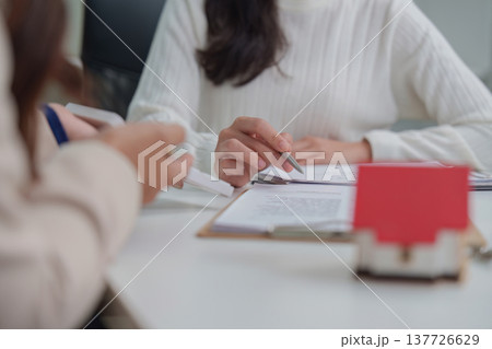 Real Estate. Close-up of hands discussing contract details in office. Real Estate. Close-up of hands discussing contract details in office. 137726629