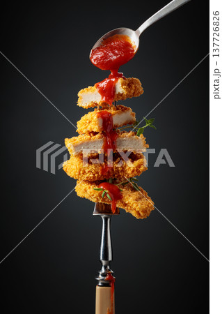 Nuggets with tomato sauce. 137726826