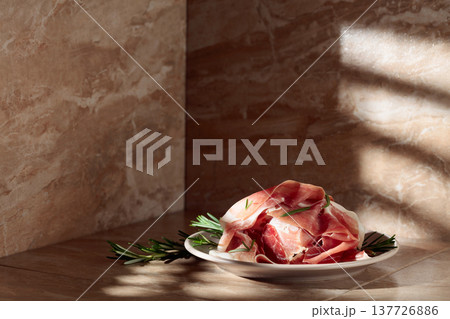 Italian prosciutto or Spanish jamon with rosemary. Italian prosciutto or Spanish jamon with rosemary. 137726886