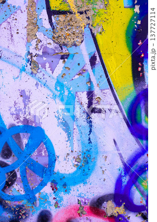 Abstract urban graffiti on textured wall, vibrant colors 90s style close-up 137727114