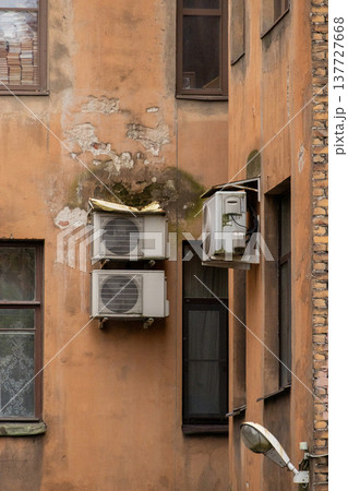 air conditioning on facade of building, air cooling in hot weather. air conditioning on facade of building, air cooling in hot weather. 137727668