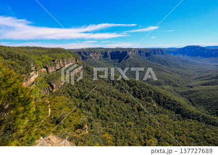Scenic view across the Blue Mountains landscape from Evans Lookout in Blackheath, New South Wales, Australia, overlooking the Grose Valley with cliffs, forest and expansive mountain scenery. Scenic view across the Blue Mountains landscape from Evans Lookout in Blackheath, New South Wales, Australia, overlooking the Grose Valley with cliffs, forest and expansive mountain scenery. 137727689