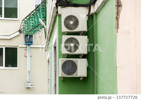 air conditioning on facade of building, air cooling in hot weather.  137727726