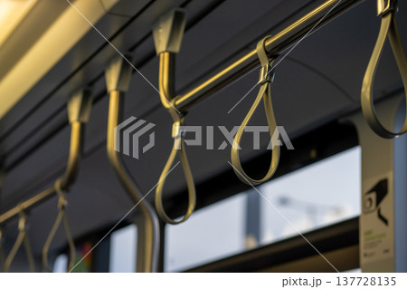 View of the upper handrail loops in public transport View of the upper handrail loops in public transport 137728135