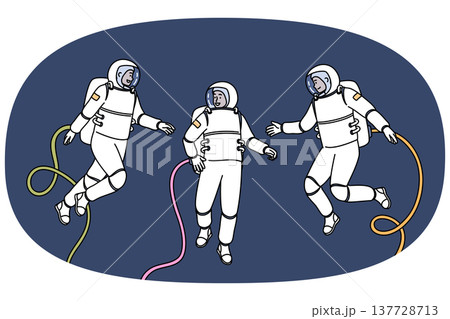 Group of astronauts participating in space research mission floats in zero gravity 137728713
