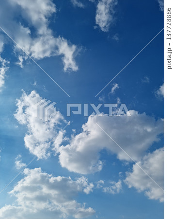 It's a blue sky with fluffy clouds. It's a blue sky with fluffy clouds. 137728886
