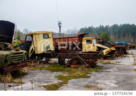 Old rusty abandoned damaged trucks in Chernobyl exclusion zone, Ukraine 137729156