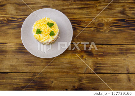Traditional russian salad Mimosa on wooden table. Top view 137729160