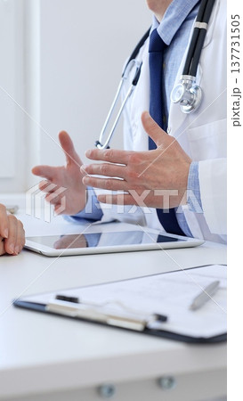 Doctor gesturing with hands while explaining diagnosis to patient during medical consultation in hospital office, healthcare and medical concept. Medicine Doctor gesturing with hands while explaining diagnosis to patient during medical consultation in hospital office, healthcare and medical concept. Medicine 137731505
