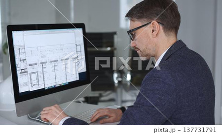 Architect developing building blueprint on computer, engineering and urban planning a new construction project. Business and architecture concept Architect developing building blueprint on computer, engineering and urban planning a new construction project. Business and architecture concept 137731791