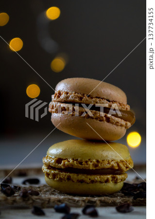 two small colored macaroons on a dark background two small colored macaroons on a dark background 137734155