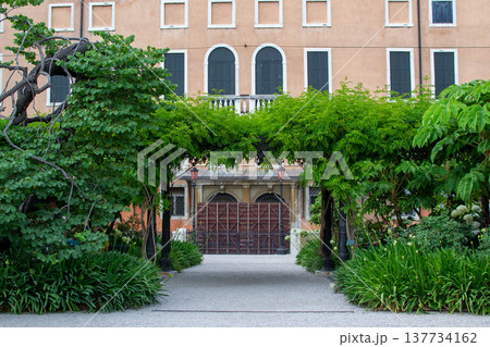 a green arch made of trees in front of the entrance to the house in Venice a green arch made of trees in front of the entrance to the house in Venice 137734162