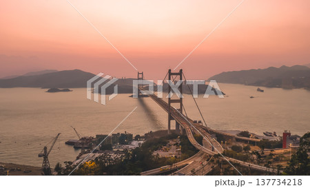 Iconic Suspension Bridge Illuminated At Sunset Over Tranquil Waters Feb 21 2026 137734218