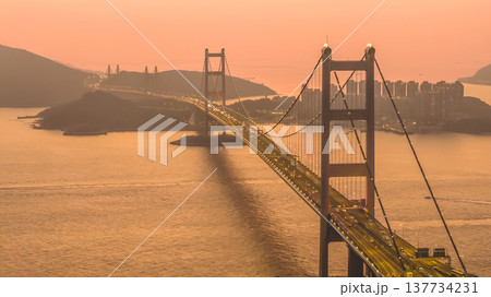 Iconic Suspension Bridge Illuminated At Sunset Over Tranquil Waters Feb 21 2026 137734231