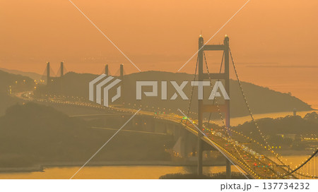 Iconic Suspension Bridge Illuminated At Sunset Over Tranquil Waters Feb 21 2026 Iconic Suspension Bridge Illuminated At Sunset Over Tranquil Waters Feb 21 2026 137734232