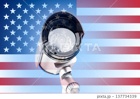 Security camera flag USA. Security camera on the textured wall with painted United States of America flag. Conceptual relation policy with neighbors. 137734339