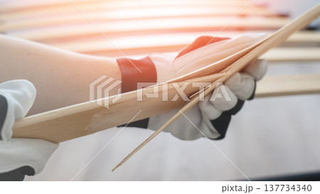 broken lamella on the bed.The master changes lamella on the bed. Broken lamella close-up by the bed. 137734340