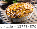 Golden-brown gratin potatoes, neatly arranged in a white ceramic bowl. However, in Slovakia, this dish is known primarily at home as French potatoes. 137734570