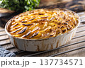 Golden-brown gratin potatoes, neatly arranged in a white ceramic bowl. However, in Slovakia, this dish is known primarily at home as French potatoes. 137734571