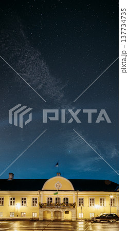 Kuressaare Town Hall with festive Christmas illumination under a starry sky at winter night 137734735