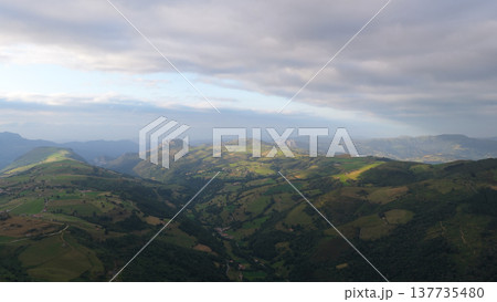 Cantabria valley with green fields and cloudy sky 137735480