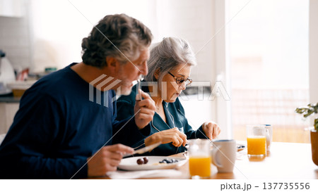 Senior couple enjoying healthy breakfast together in kitchen Senior couple enjoying healthy breakfast together in kitchen 137735556
