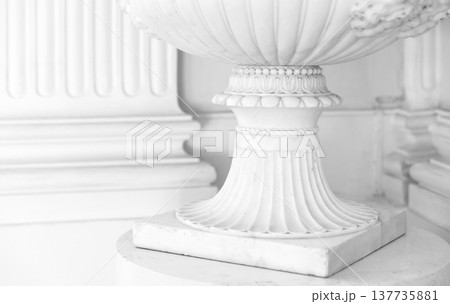 Elegant white stone pedestal showcasing intricate details and a classical design 137735881