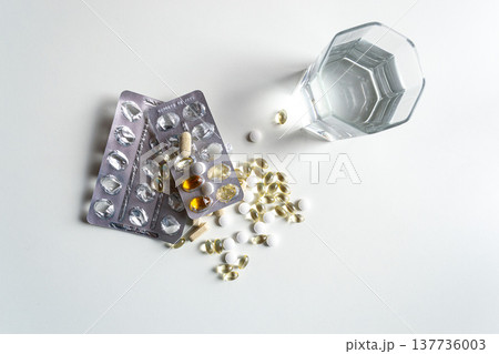 Variety of forms and blisters of vitamin D on a white table 137736003